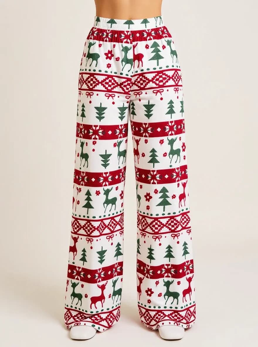 A pair of wide-leg Christmas pajama pants photographed against a plain white background. The pants feature a repeating pattern of green deer silhouettes, dark green Christmas trees, red snowflakes, and geometric Nordic-style patterns in red and green. The pattern consists of horizontal bands across the pants with a red and white geometric border design. The deer are depicted in a simple, stylized manner facing left, while the Christmas trees are shown in a traditional evergreen color. Small red flowers and white snowflake designs are scattered throughout the pattern. The pants have an elastic waistband and are made of a soft, casual fabric material. The bottom hem of the pants is straight and the legs are full-length. The image shows the pants from waist to ankle, with the pants laid flat to display the complete pattern.