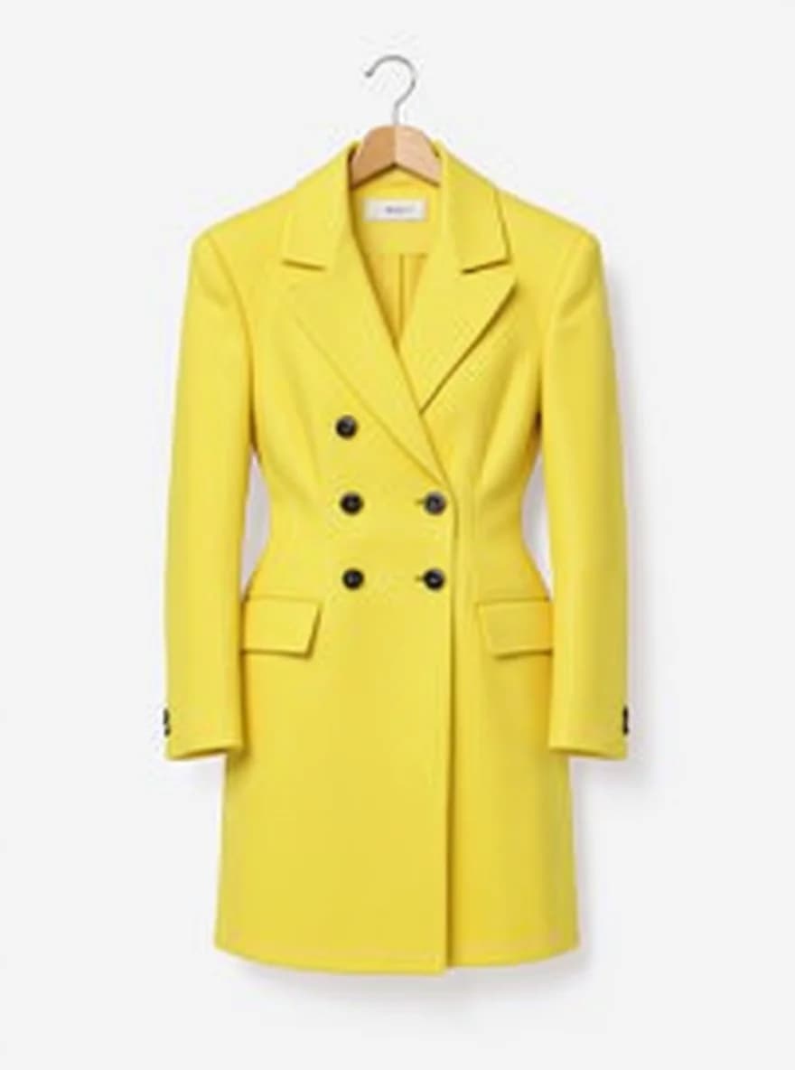 A bright yellow double-breasted wool coat hanging on a wooden hanger against a white background. The coat features six black buttons arranged in a symmetrical double-row pattern down the front. It has classic notched lapels, two front patch pockets, and long sleeves with buttoned cuffs. The coat is knee-length in length and maintains a structured, tailored silhouette. The fabric has a fine wool texture with a subtle sheen. The wooden hanger has a natural finish and curved shoulders to maintain the coat's shape. The image is a clean, professional product photograph with even lighting that highlights the vibrant yellow color of the garment.
