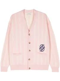 A light pink cardigan sweater with a V-neck design and five brown buttons down the front. The sweater has two front patch pockets and is made of a ribbed knit material. On the left chest area, there is a navy blue embroidered logo consisting of the letters "SD" intertwined. The cardigan has long sleeves and a relaxed, oversized fit. The image shows the sweater laid flat against a white background, photographed from directly above. The sweater has a classic, preppy aesthetic with clean lines and minimal detailing.